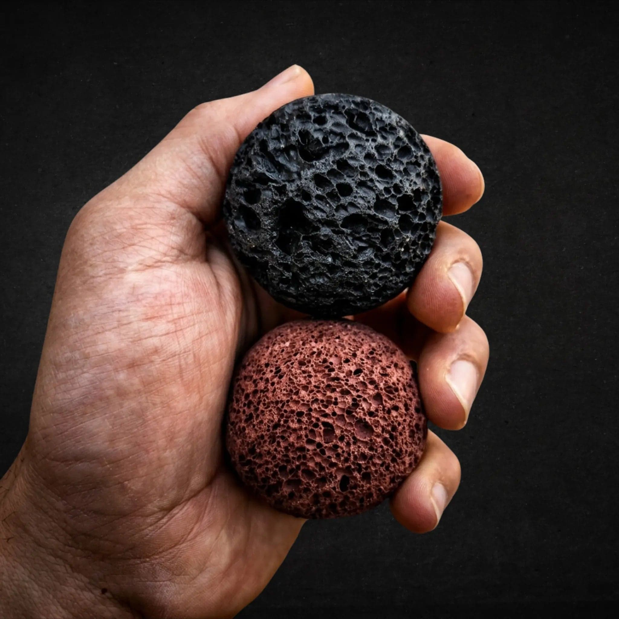 A hand holding both Basalt Orbs, Moon and Mars