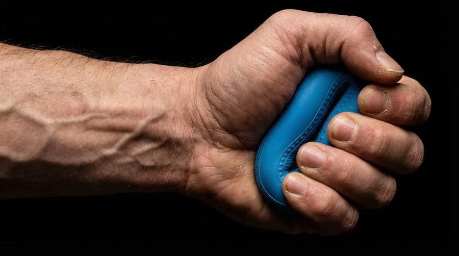 A fist crushing a Dad Hands grip ring