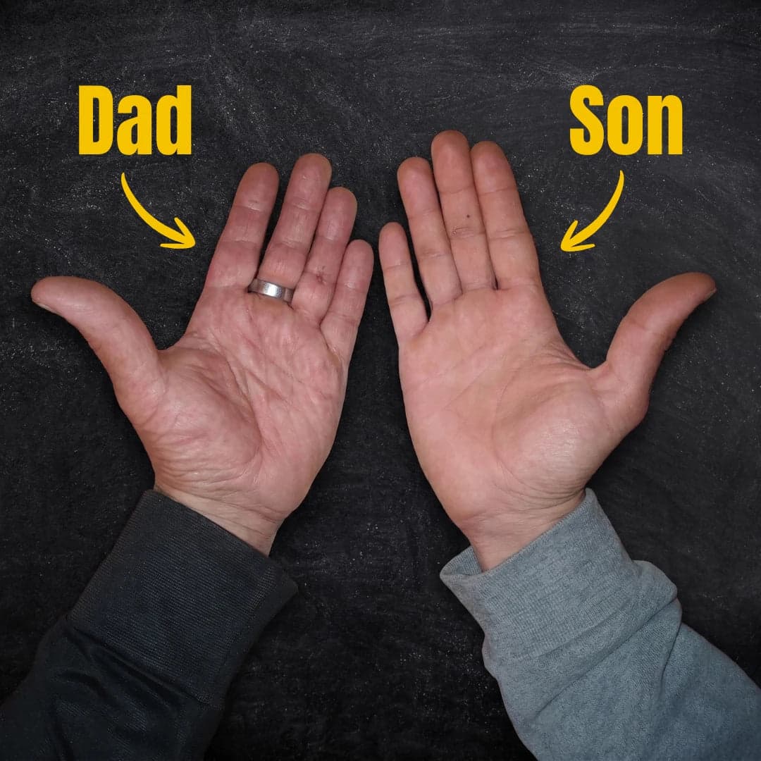 A father's worked hands next to his son's office hands