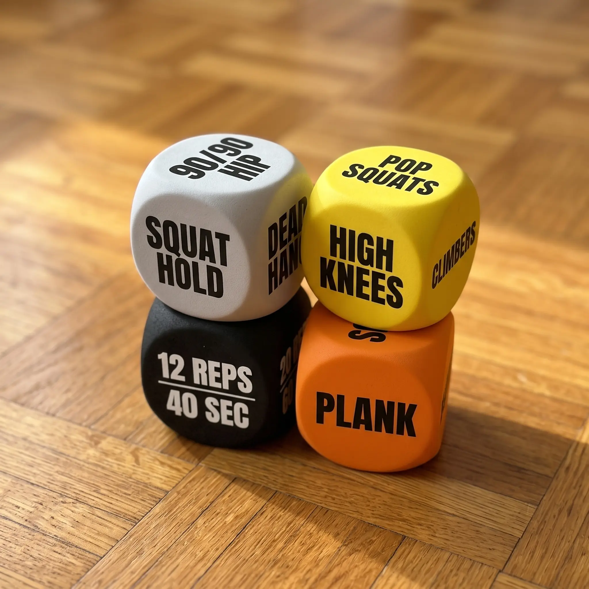 The four dice stacked on a parquet floor